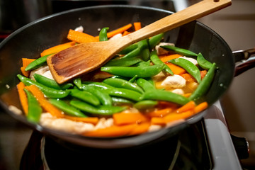 close up of chicken dinner cooking on the hob