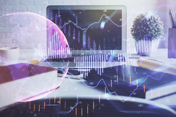 Financial chart drawing and table with computer on background. Double exposure. Concept of international markets.