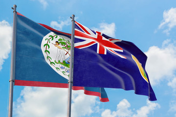 Turks And Caicos Islands and Belize flags waving in the wind against white cloudy blue sky together. Diplomacy concept, international relations.