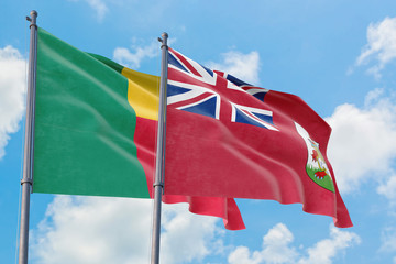 Bermuda and Benin flags waving in the wind against white cloudy blue sky together. Diplomacy concept, international relations.