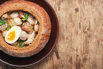 Polish soup zurek in bread pot