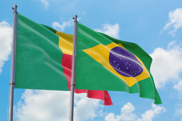 Brazil and Benin flags waving in the wind against white cloudy blue sky together. Diplomacy concept, international relations.
