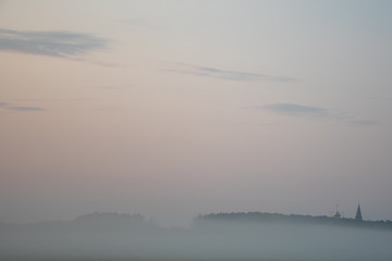 Obraz na płótnie Canvas Christian church in the morning autumn fog