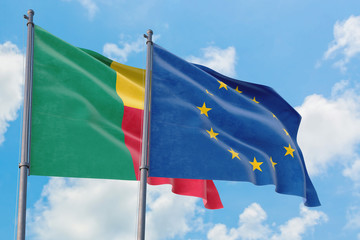 European Union and Benin flags waving in the wind against white cloudy blue sky together. Diplomacy concept, international relations.
