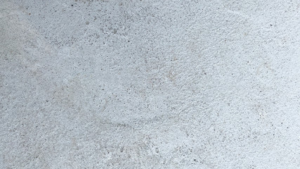 Texture of old gray concrete wall for background. Closeup fragment of grunge weathered wall of a building.