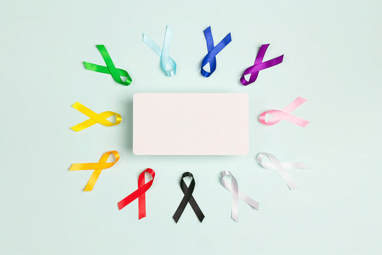 Colorful awareness ribbons with place for text on blue background. World cancer day concept, February 4