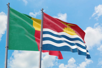 Kiribati and Benin flags waving in the wind against white cloudy blue sky together. Diplomacy concept, international relations.