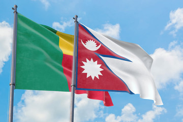 Nepal and Benin flags waving in the wind against white cloudy blue sky together. Diplomacy concept, international relations.