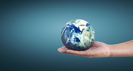 Globe ,earth in human hand, holding our planet glowing