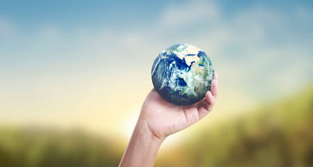 Globe ,earth in human hand, holding our planet glowing