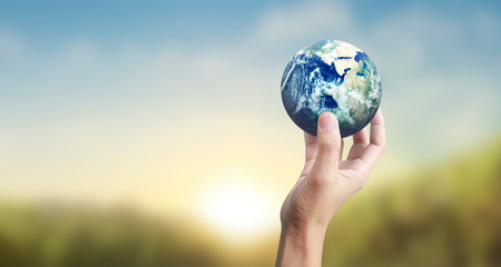 Globe ,earth in human hand, holding our planet glowing