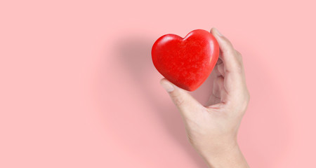Fototapeta premium Hands holding red heart, heart health, and donation concepts