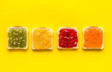 Toast with jam. Colorful set on yellow background top-down copy space