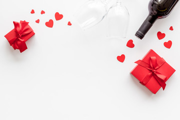 Valentines Day concept with wine and red present box on white background top-down copy space