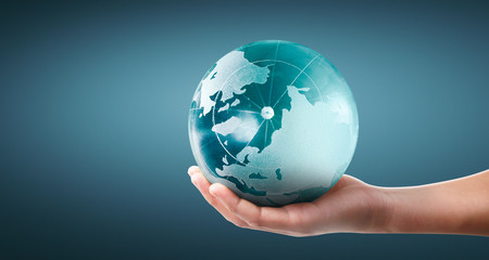 Globe ,earth in human hand, holding our planet glowing