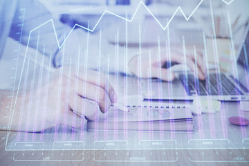 Multi exposure of financial graph with man works in office on background. Concept of analysis.