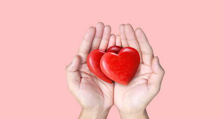 Fototapeta premium Hands holding red heart, heart health, and donation concepts
