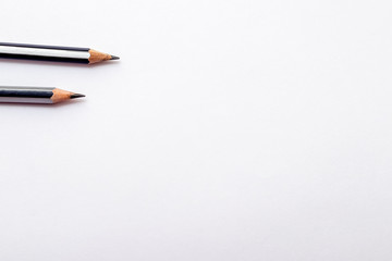 Pencils and eraser on white paper background. Copy space_