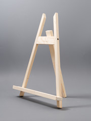 easel made of wood table on a gray background