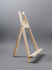 easel made of wood table on a gray background