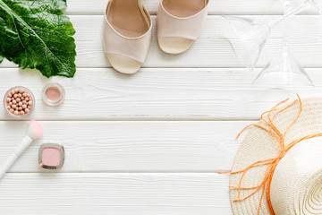 Obraz premium Women fashion concept. Dress, shoes, cosmetics on white wooden background top-down frame copy space