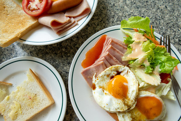 Breakfast. Bread, ham, sausage and fruit.
