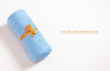 Rolled blue terry towel tie up by orange ribbon against a white background with empty space for...