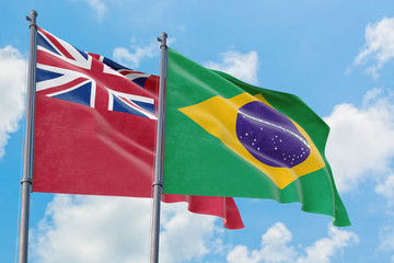 Brazil and Bermuda flags waving in the wind against white cloudy blue sky together. Diplomacy concept, international relations.