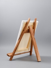 easel made of wood table on a gray background