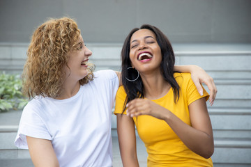 happy woman with different skin color friend spending good time together; concept of ethnicity and skin color difference tolerance, love and peace, friendship, social diversity