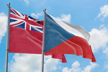 Czech Republic and Bermuda flags waving in the wind against white cloudy blue sky together. Diplomacy concept, international relations.
