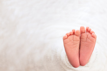  Foot of the newborn baby, tenderness. copy space in winter concept