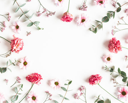 Flowers composition. Frame made of pink flowers and eucalyptus branches on white background. Valentines day, mothers day, womens day concept. Flat lay, top view