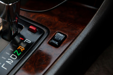The car panel is next to the speed switch with letters designating the gears and the transmission control buttons and the stabilization system.