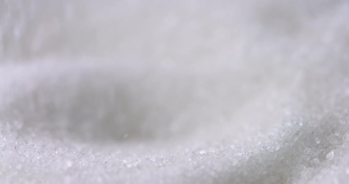 Sugar or Salt taken with Spoon from a bowl at closeup. Slow motion, 4k resolution