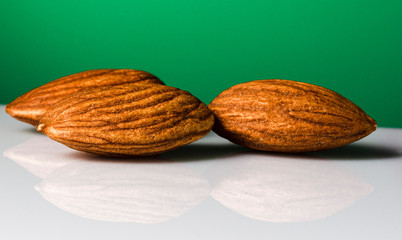 Almond nuts on a green background