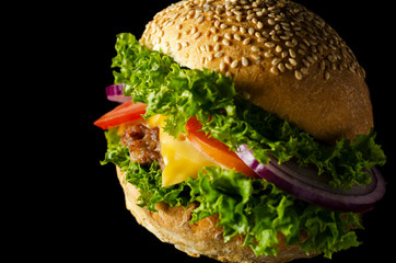 tasty cheeseburger on a black background