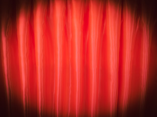 The light and shadow of the curtains on vintage theatre. Glossy red curtain background.