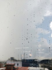 Water drops on glass, rain on a window background. drops of water-repellent surface in black &...