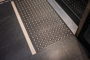 High angle view tactile ground surface indicators at the access point for subway train in Brescia (Italy).