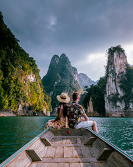 Khao Sok Thailand, couple on vacation in Thailand, men and woman in longtail boat at the Khao Sok...