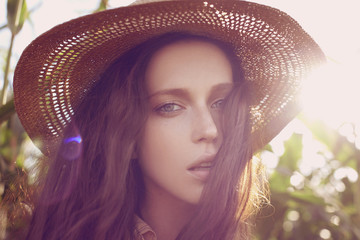 Beautiful young woman in a hat. Sunny lifestyle fashion portrait  - 320505574