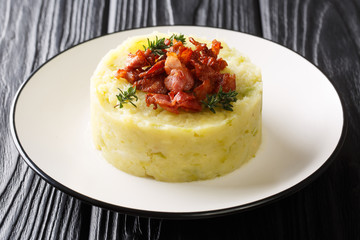 recipe for a traditional Trinxat mashed potato and green cabbage with fried bacon closeup in a plate. horizontal