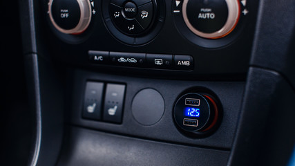Fototapeta premium USB charge in car, voltage car battery, conditioner buttons.
