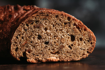 Freshly baked rustic bread on the rustic background. Selective focus. Shallow depth of field.