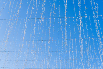 Christmas garlands on a blue sky background.