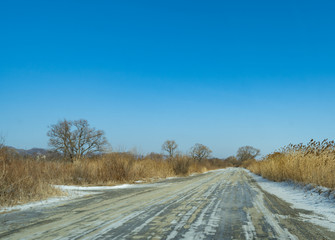 Country road on the background of a winter landscape.