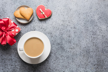 Valentines day card with heart cookies, love letter, coffee cup on grey table.