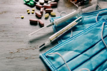 Fototapeta premium Novel coronavirus 2019-nCoV, MERS-Cov middle East respiratory syndrome. Protective medical mask and medicines, pills against the virus. Wuhan pneumonia virus