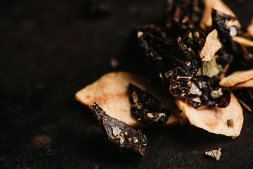 Italian spices on the black rustic background. Selective focus. Shallow depth of field.